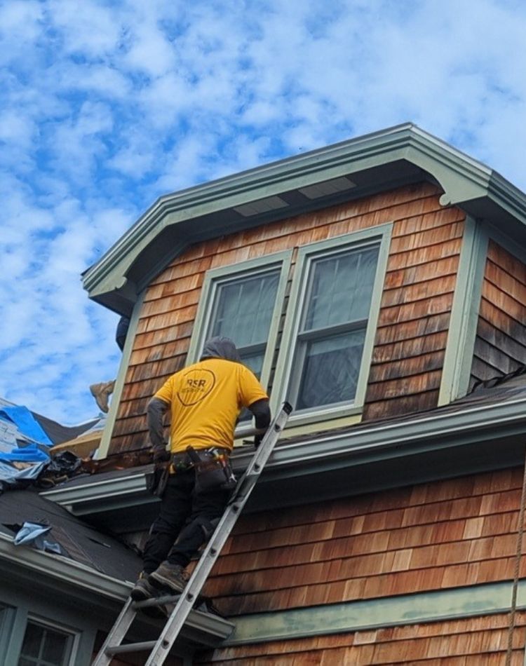 Professional roof installation in Groton, CT with new asphalt shingles being installed on a coastal New England home ct